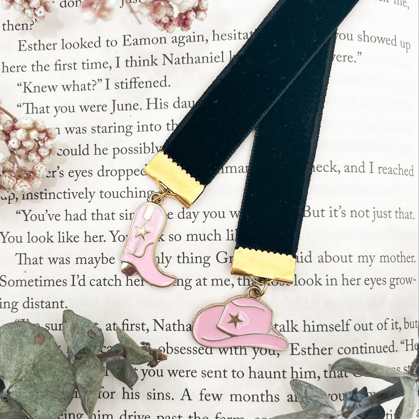 Black ribbon with gold accents and pink cowboy hat and boot charms