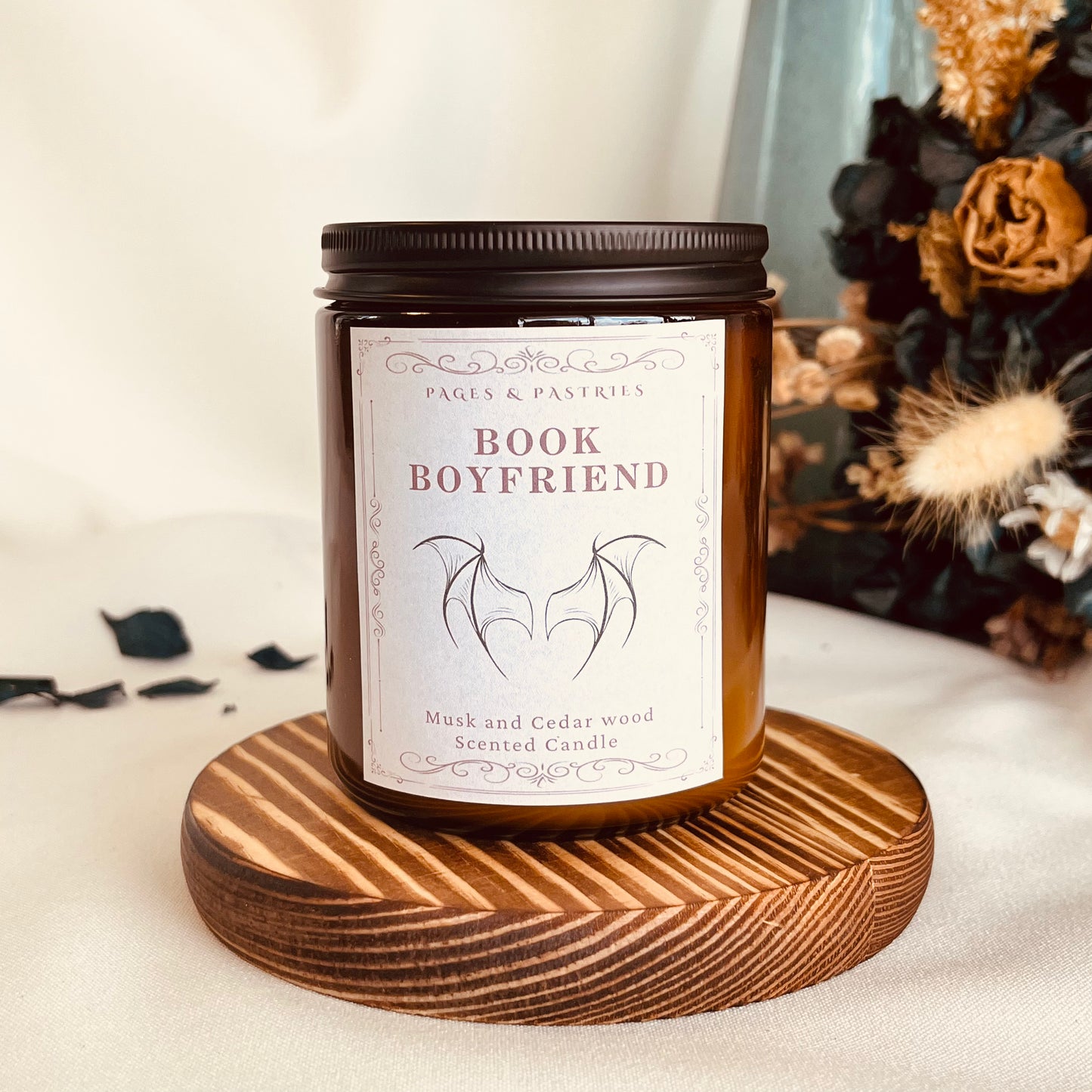Book Boyfriend bookish candle in amber glass jar with black lid and musk and cedarwood scent