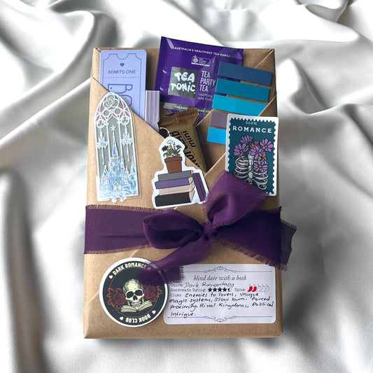 Gift package with a purple ribbon on a white fabric background