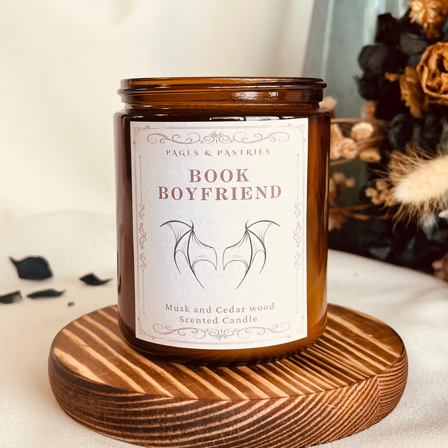 Book Boyfriend bookish candle in amber glass jar showing Illyrian wings on the label
