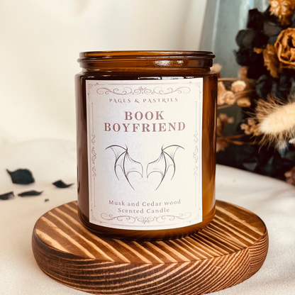 Book Boyfriend bookish candle in amber glass jar showing Illyrian wings on the label