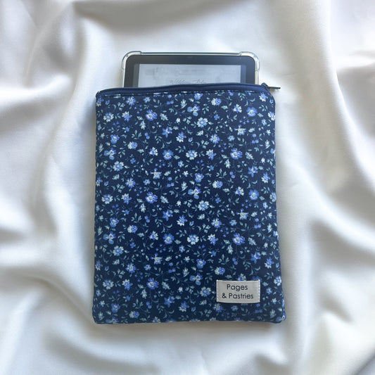 Floral-patterned e-reader case on a white fabric background