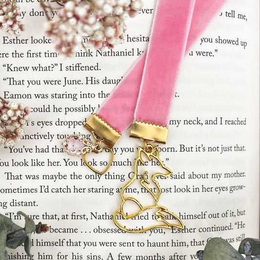 Pink velvet ribbon bookmark with a pink crystal and heart on one side and a golden fox on the other