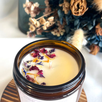 Wild Flowers bookish candle in amber glass jar topped with dried wildflowers