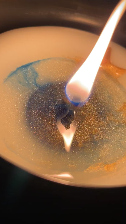 City of Starlight bookish candle burning video showing gold stars melting into blue glittery wax with flickering flame